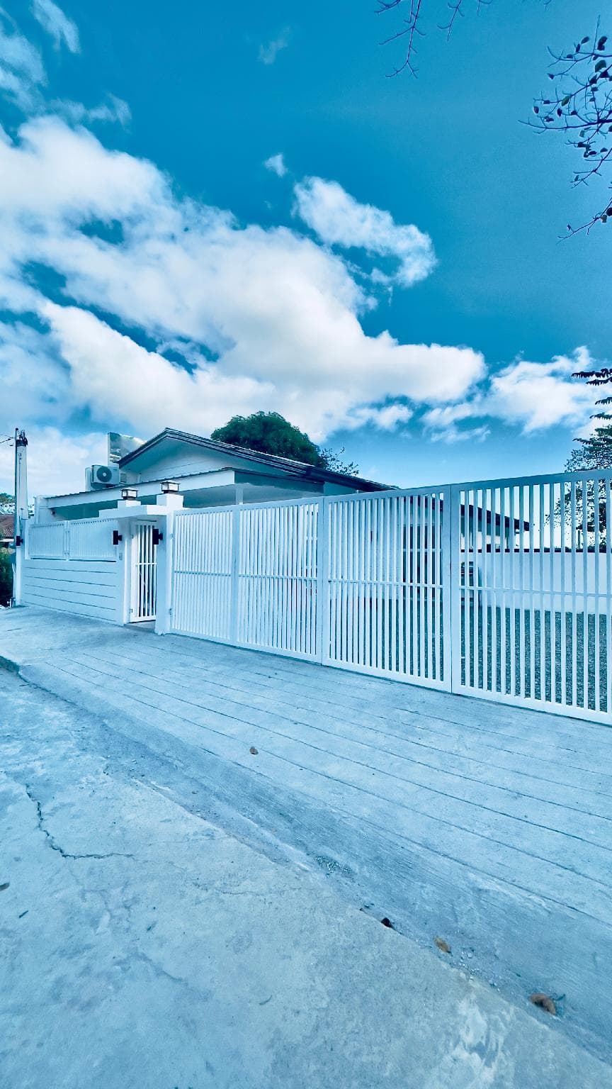 The gated entrance and carport at dusk