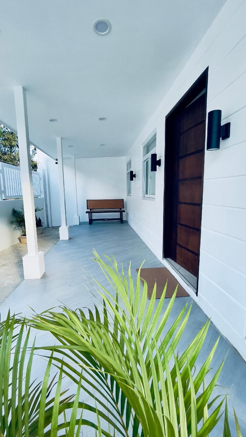 The covered porch with a bench by the front door